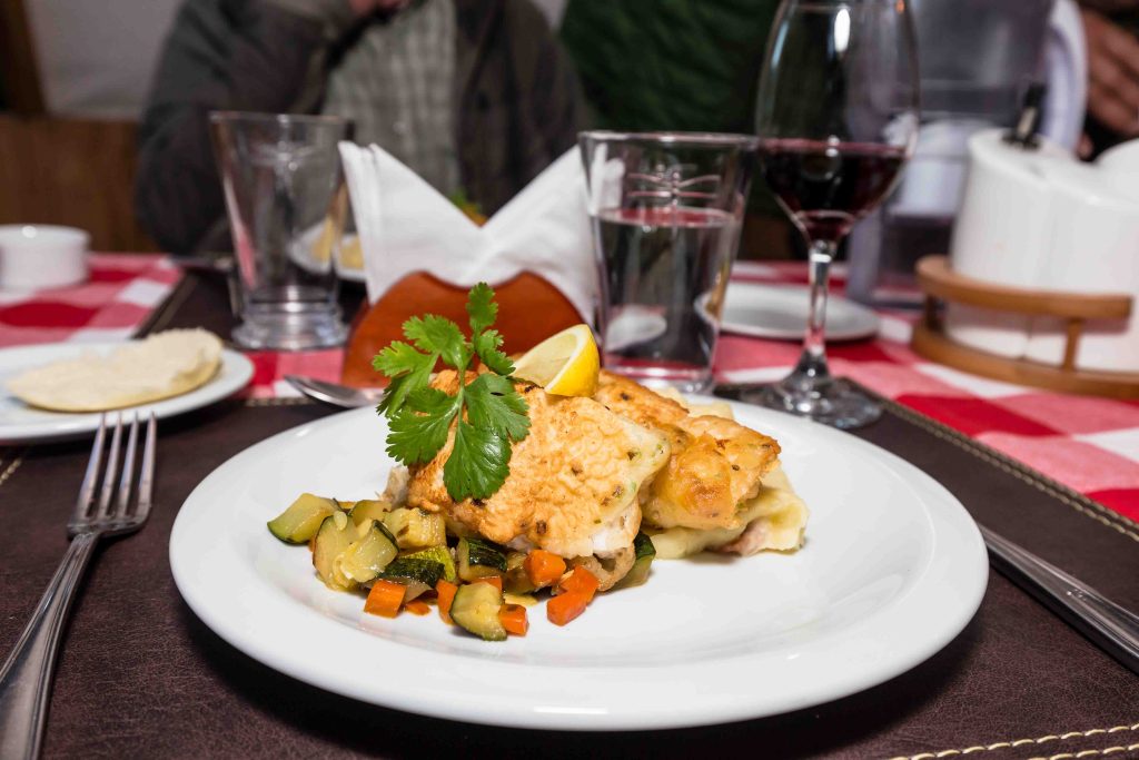 Gourmet fish dish with vegetables served at the camp