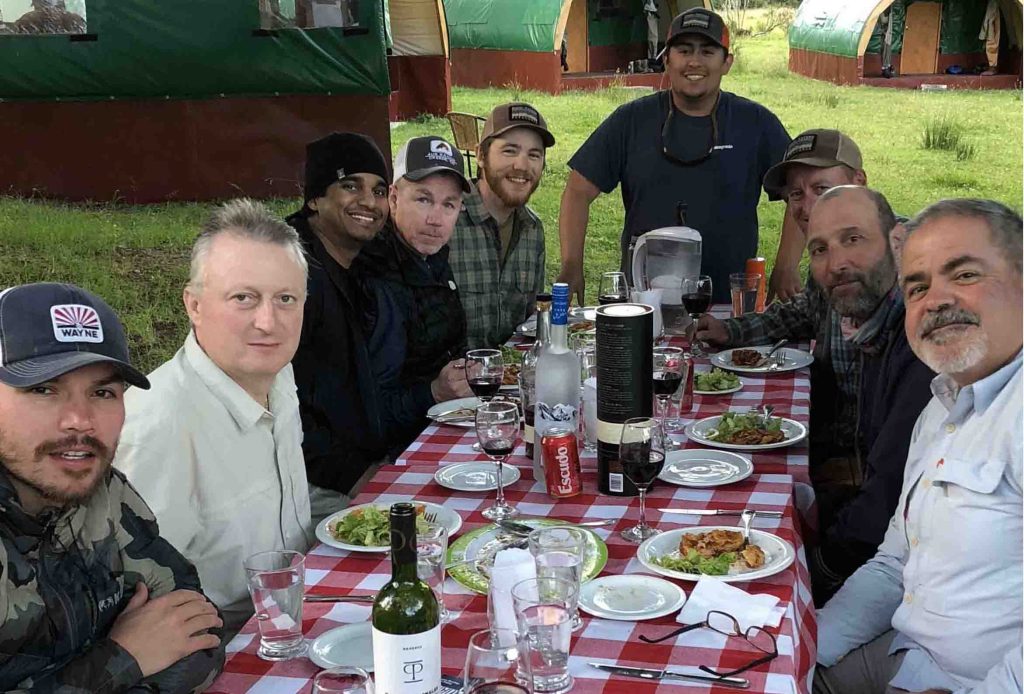 Guests sharing dinner at the camp dining table