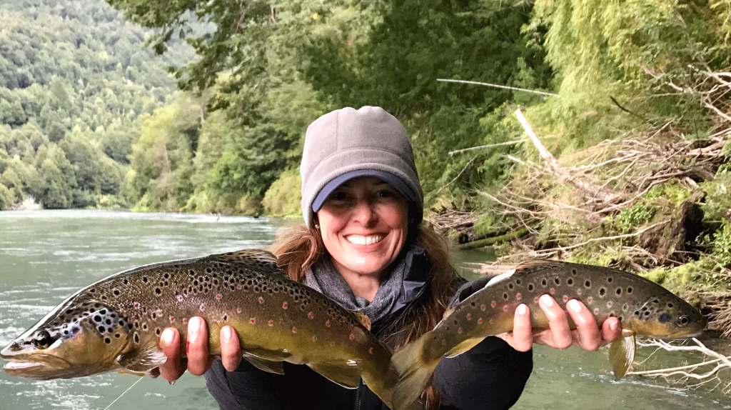 Angler holding two brown trout at River of Dreams